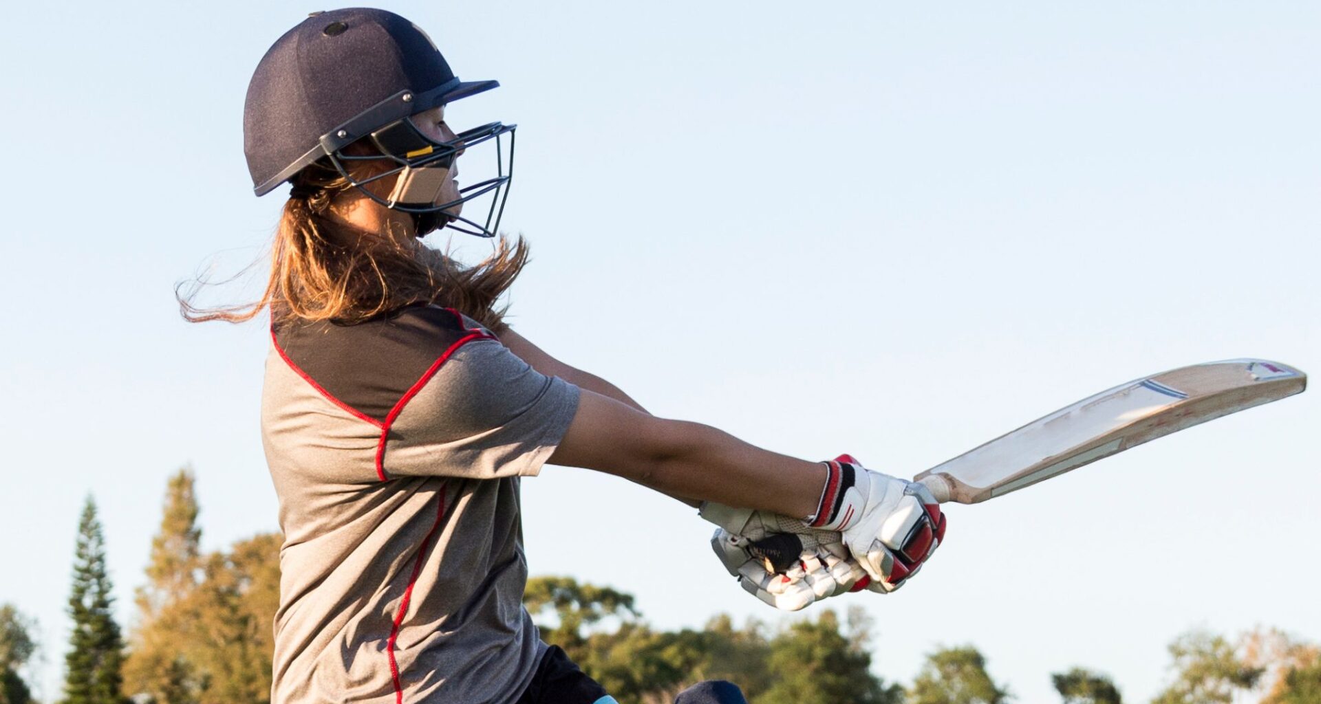 Someone swinging a cricket bat.