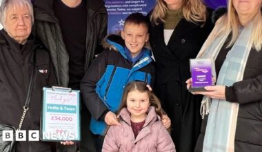 A group of people under a purple tent.