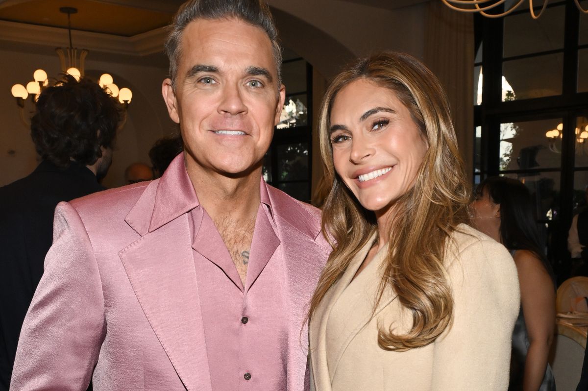 Robbie Williams wearing pink and Ayda Field wearing cream at a 2024 event