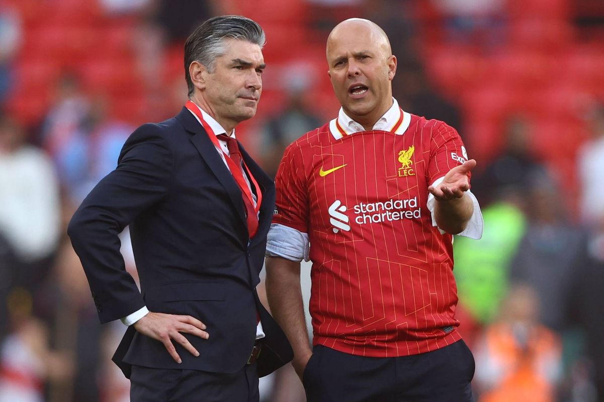 Arne Slot speaks with sporting director Richard Hughes after lifting the Premier League title last season