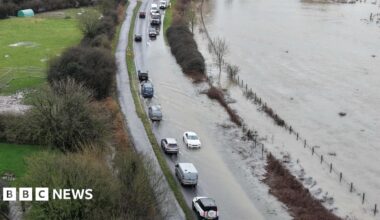 Vehicles on a road that is flood due to storm Chandra and the heavy rain last week.