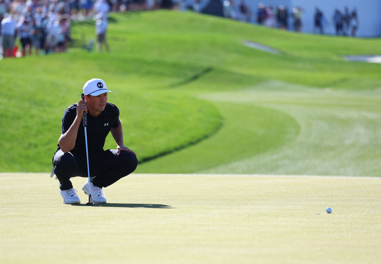Jordan Spieth of the United States lines up his putt on hole 18 during the first round of the WM Phoenix Open golf tournament