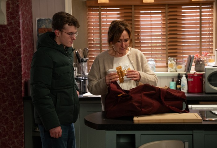 22_01_emm_arthur_laurel_03 Arthur and Laurel pull drugs out of a red bag in Emmerdale.