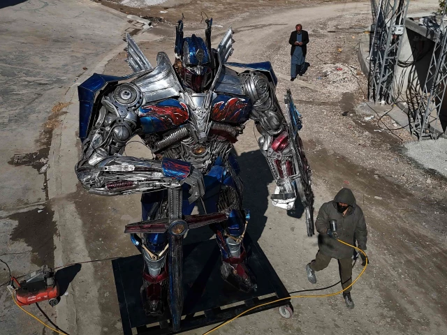 sculptor ehtisham jadoon working on a model of optimus prime a film character from transformers made from scrap metal at his studio on the outskirts of islamabad photo afp