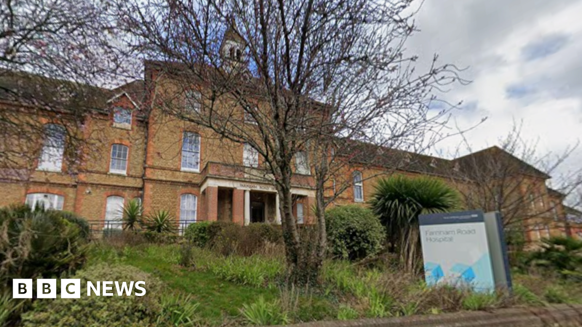 A Google Street image of the outside of a red brick hospital. It says "Farnham Road Hospital" on the sign.