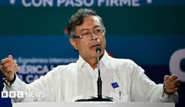 Colombian President Gustavo Petro wearing a white shirt on stage at an event in Panama City on 26 January