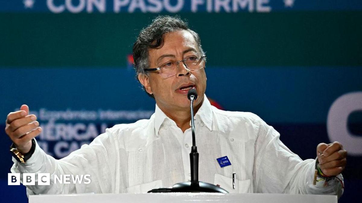 Colombian President Gustavo Petro wearing a white shirt on stage at an event in Panama City on 26 January