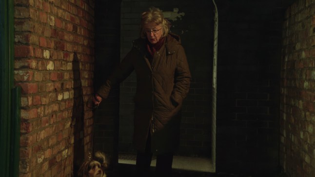 Evelyn walks down a ginnel in Corrie