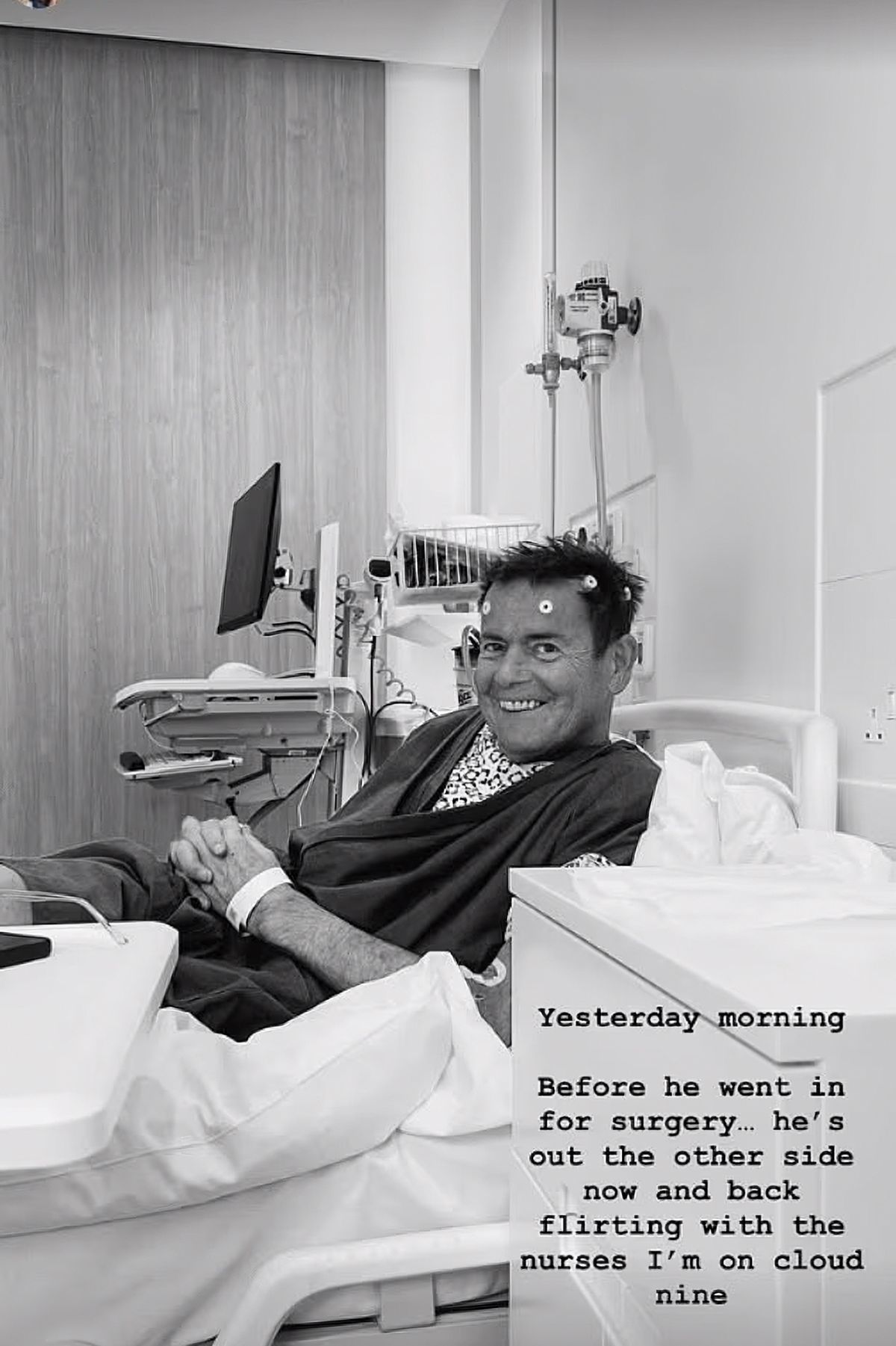 Black and white image of John Andrews recovering in a hospital bed