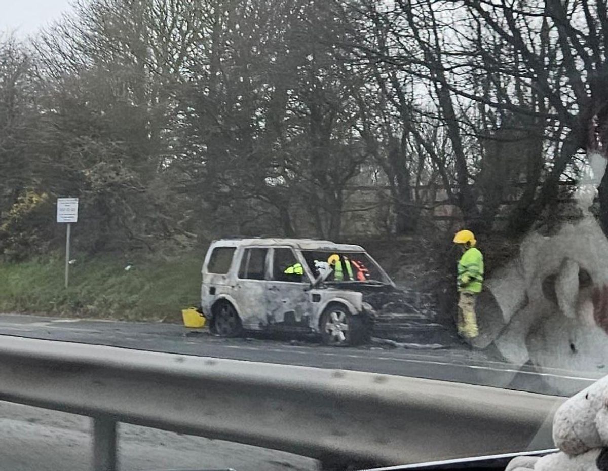 Burnt out car on the side of the A55 