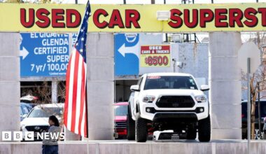 A mother kneels next to her toddler son