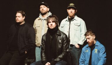 While She Sleeps looking solemn against a black background