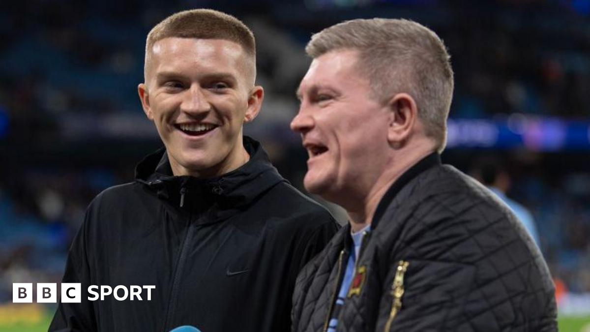 Campbell Hatton stands and laughs alongside his father Ricky Hatton
