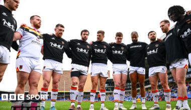 Bradford Bulls players link arms in a huddle before the Challenge Cup tie against London