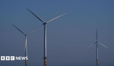 Three wind turbines. The sky is blue.