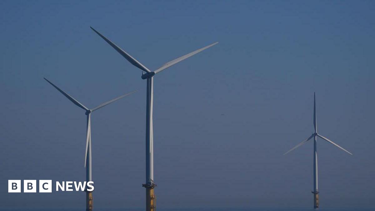 Three wind turbines. The sky is blue.
