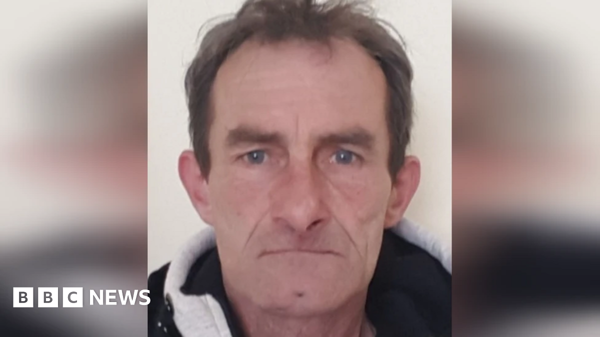 A mugshot of Andrzej Mucha, who has short, brown hair.