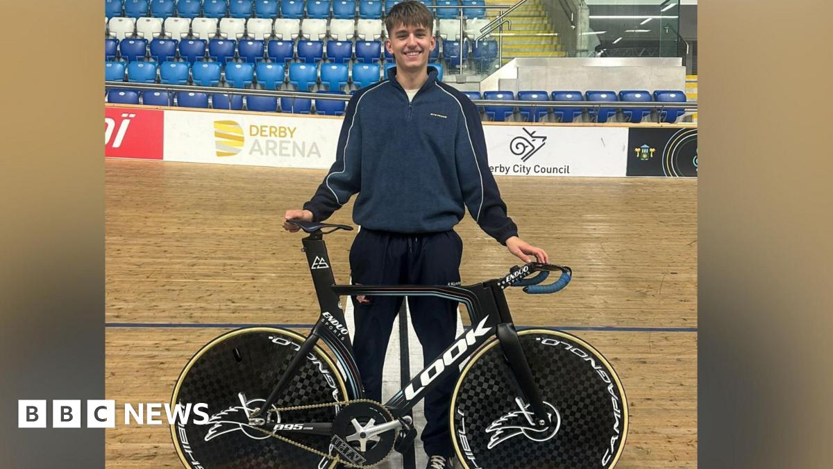 Lewis stood on the Derby Arena velodrome track with his racing bike.
