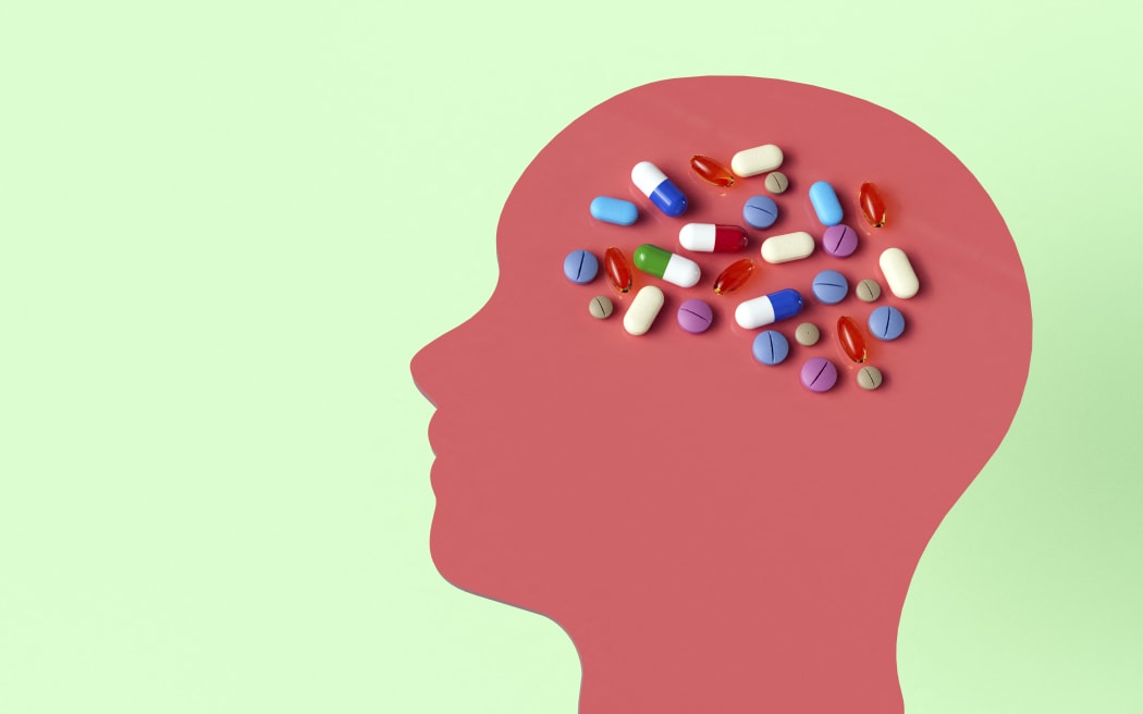 Conceptual illustration showing drugs that target the human brain to treat neurological disorders.