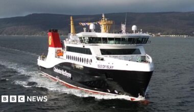 A black and white ferry on water with Caledonian MacBrayne written on it, with Isle of Islay written near the front