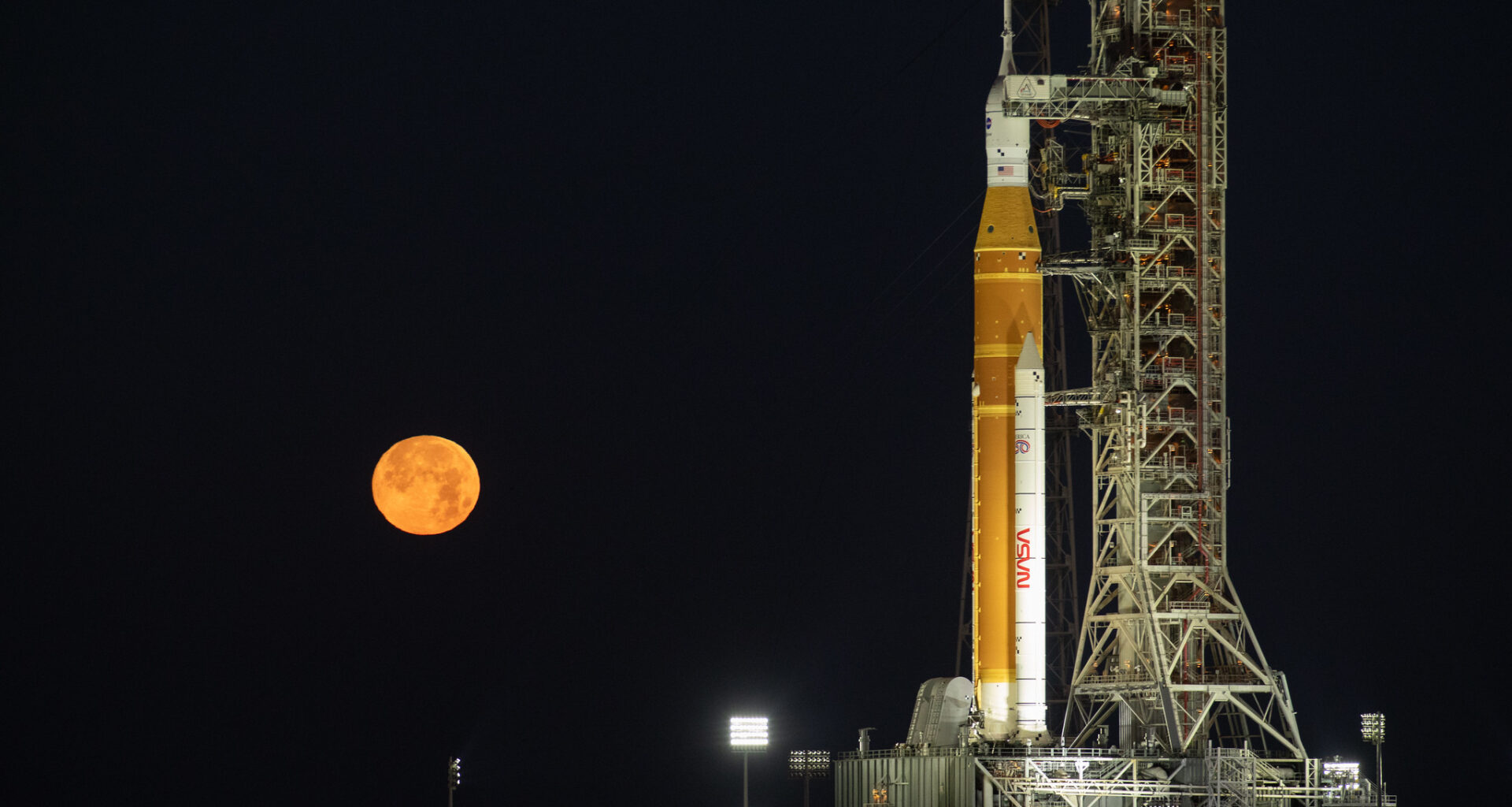 The Moon rises behind NASA’s Artemis II SLS (Space Launch System) rocket and Orion spacecraft atop a mobile launcher at Launch Complex 39B at NASA’s Kennedy Space Center in Florida on Sunday, Feb. 1,. 2026. The Artemis II test flight will take Commander Reid Wiseman, Pilot Victor Glover, and Mission Specialist Christina Koch from NASA, and Mission Specialist Jeremy Hansen from the CSA (Canadian Space Agency), around the Moon and back to Earth.