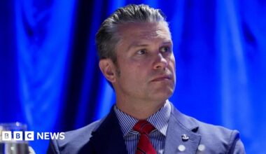 US Secretary of Defense Pete Hegseth wears a blue suit and red tie at a recent prayer breakfast in Washington
