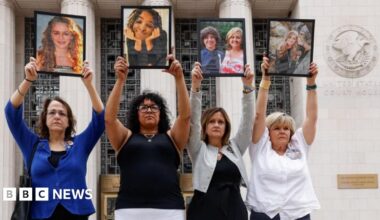 Four parents holding up framed photos of their children, whom they say died due to social media–related harms standing alongside one another outside a courthouse in Los Angeles.