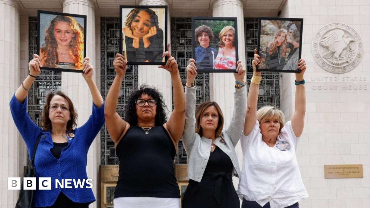 Four parents holding up framed photos of their children, whom they say died due to social media–related harms standing alongside one another outside a courthouse in Los Angeles.