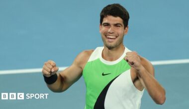 Carlos Alcaraz hugs the Australian Open trophy
