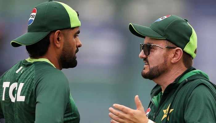 Pakistan head coach Mike Hesson (right) talks to batter Babar Azam during their training session at the Sinhalese Sports Club Ground in Colombo on February 17, 2026. — ICC