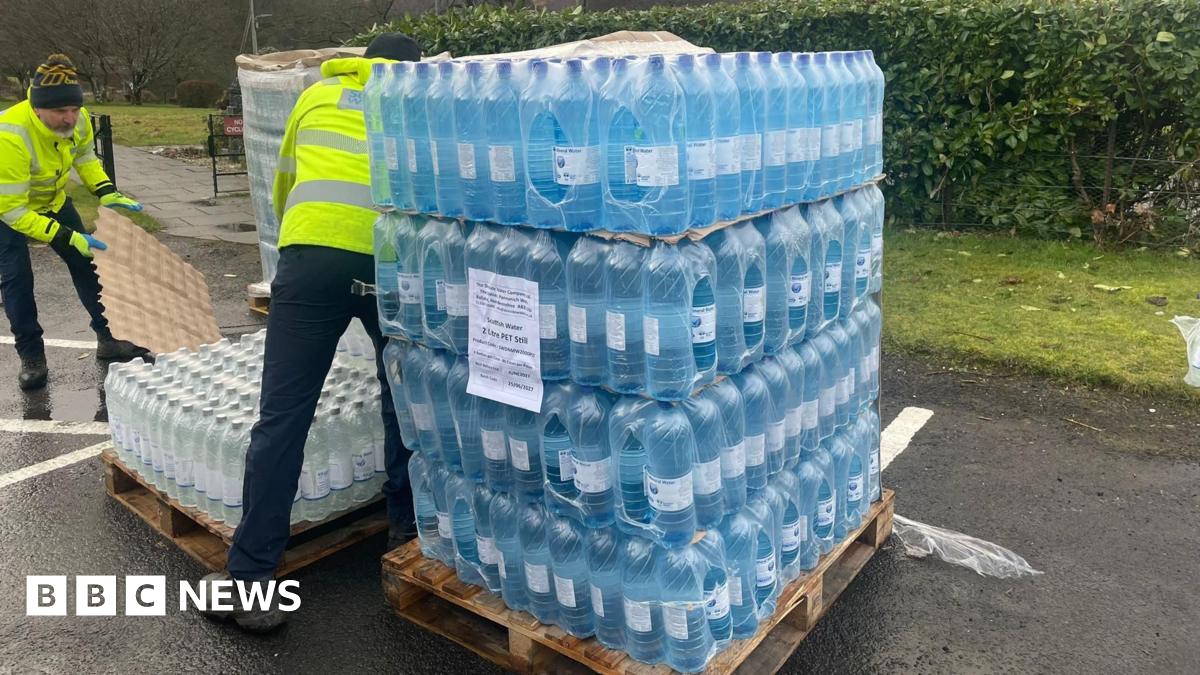 Two men unloading a pallet of bottled water