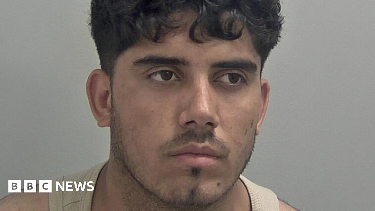 Ahmad Mulakhil wears a light brown vest. He has curly black hair over his forehead and slight black stubble.