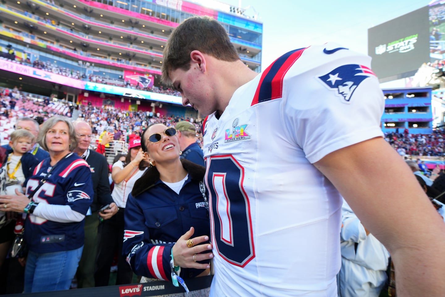 New England Patriots quarterback Drake Maye (10) hugs his wife Ann Michael before the NFL Super Bowl 60 football game against the Seattle Seahawks, Sunday, in Santa Clara, Calif.