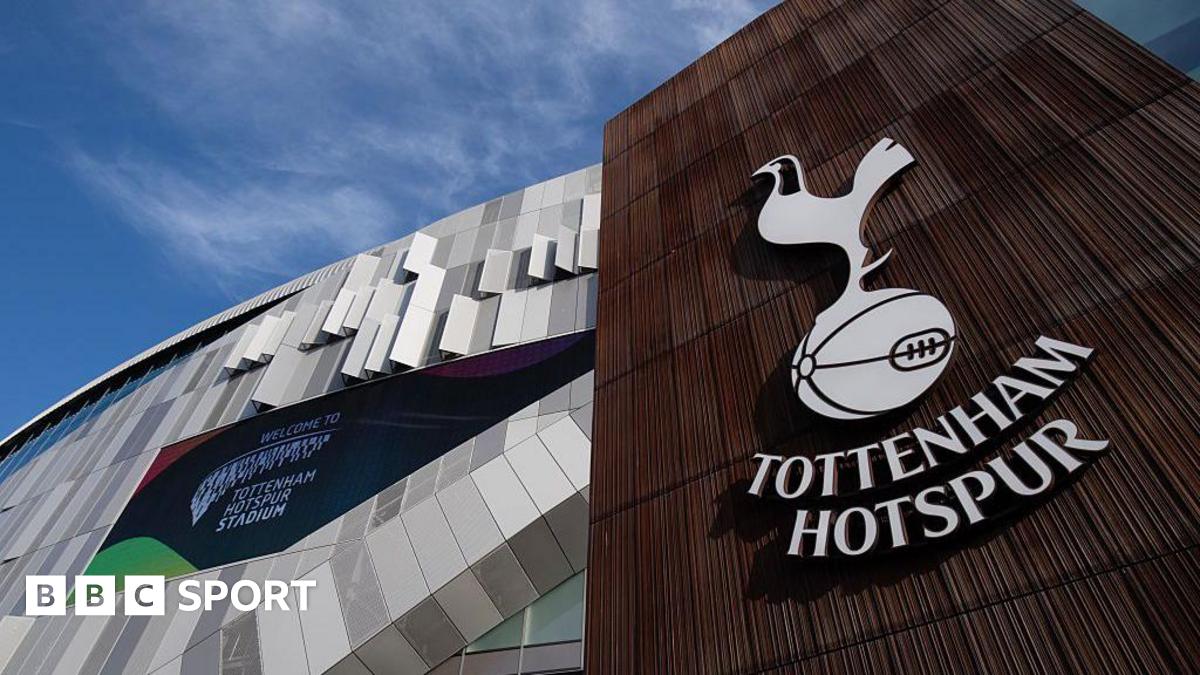 A Tottenham Hotspur logo on a wall outside Tottenham Hotspur Stadium