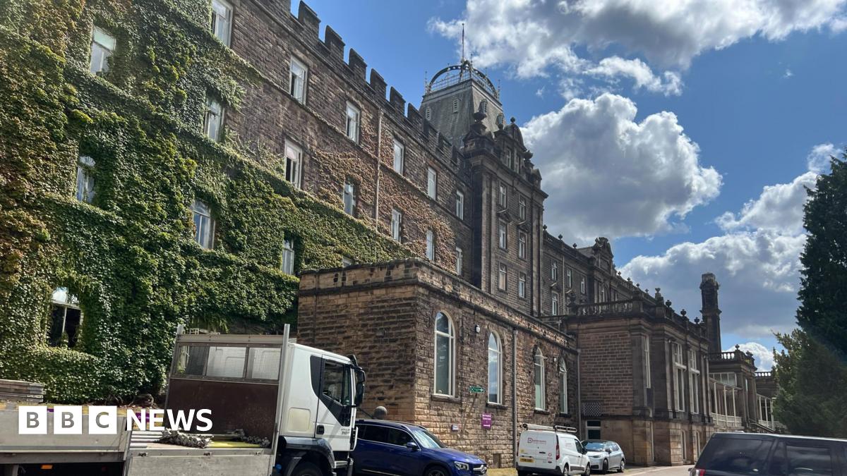 Listed Victorian stone county hall building covered in moss on left side