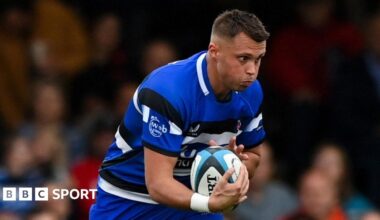 Bath's Tom Carr-Smith holds the ball with a determined look on his face