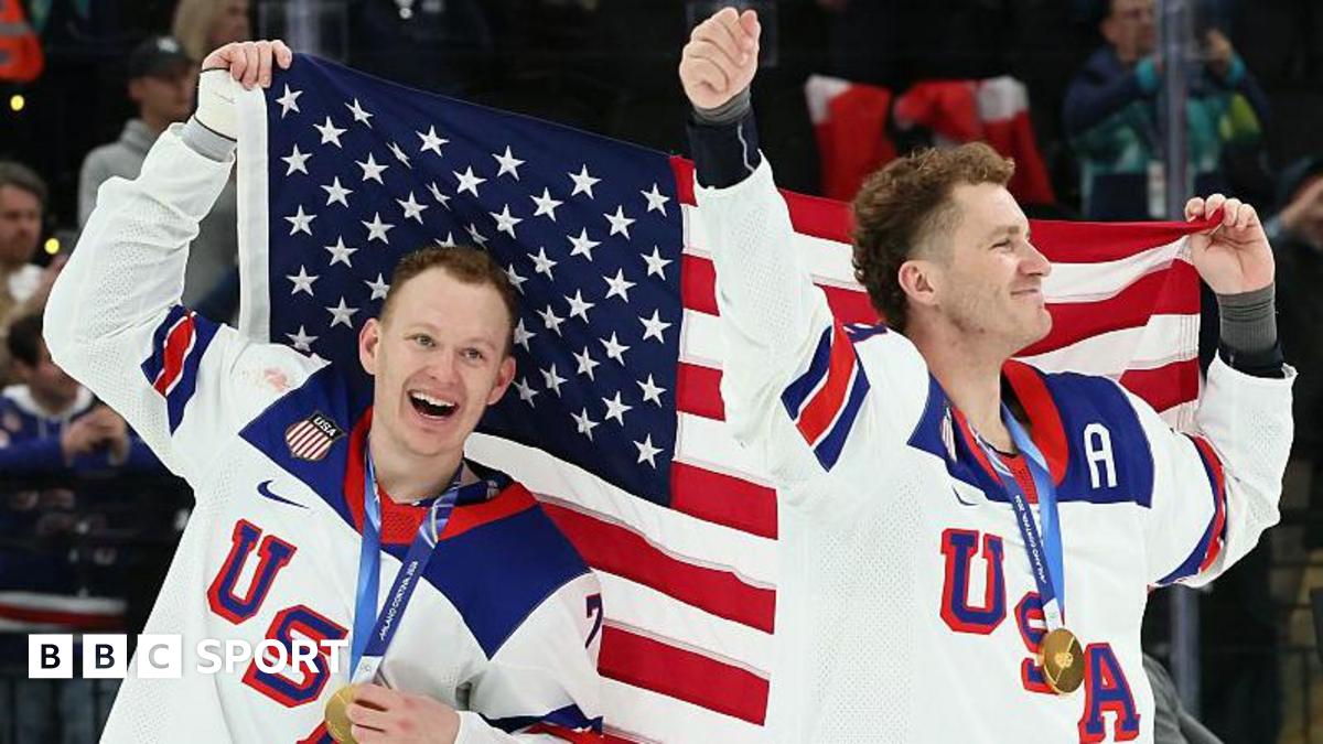 Brady Tkachuk and Matthew Tkachuk hold aloft the United States flag after helping the men's ice hockey team beat Canada to win gold at the 2026 Winter Olympics