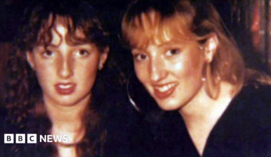 Victoria Hicks, who has brown wavy hair looks into the camera next to her sister Sarah, who has blonde shoulder length hair and is wearing large hoop earings.