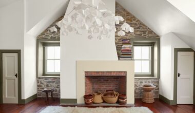 living space with white walls, sloped ceiling and wooden floor