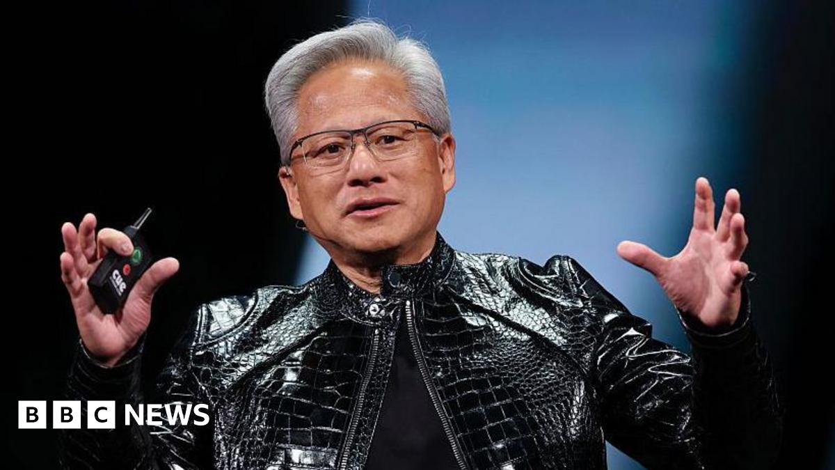 Nvidia's Jensen Huang, in his iconic black leather jacket, speaks on stage, gesturing with his hands up
