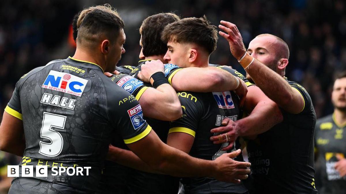 Leeds Rhinos player George Brown is congratulated by team-mates after scoring a try against Widnes Vikings.