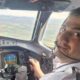 Mr Abbasi, sitting in the cockpit of an aircraft in front of the control system. He wears a pilot's shirt and earpiece and is flying the plane in this picture.