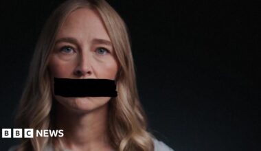 A survivor of Jeffrey's Epstein's abuse looks at the camera and appears with a black redaction mark across her mouth