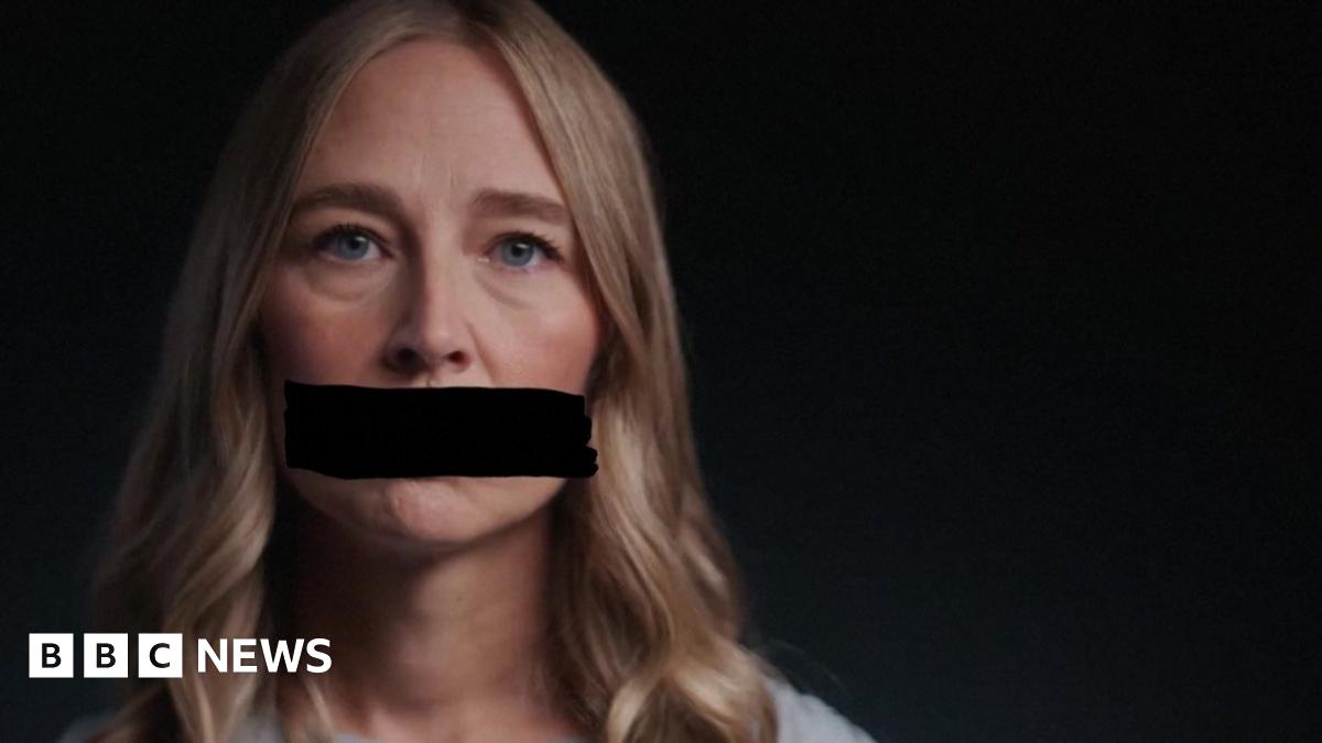 A survivor of Jeffrey's Epstein's abuse looks at the camera and appears with a black redaction mark across her mouth