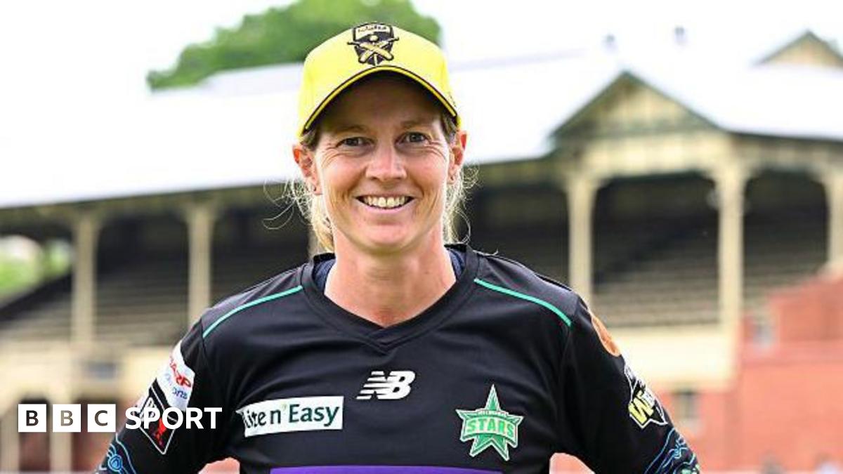 Meg Lanning looking straight at the camera with a big smile and wearing a black Melbourne Stars kit