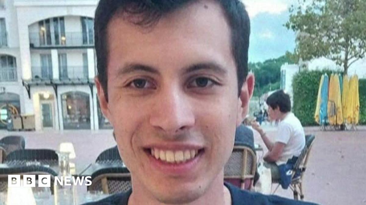 A  young man called Quentin Deranque sits outside