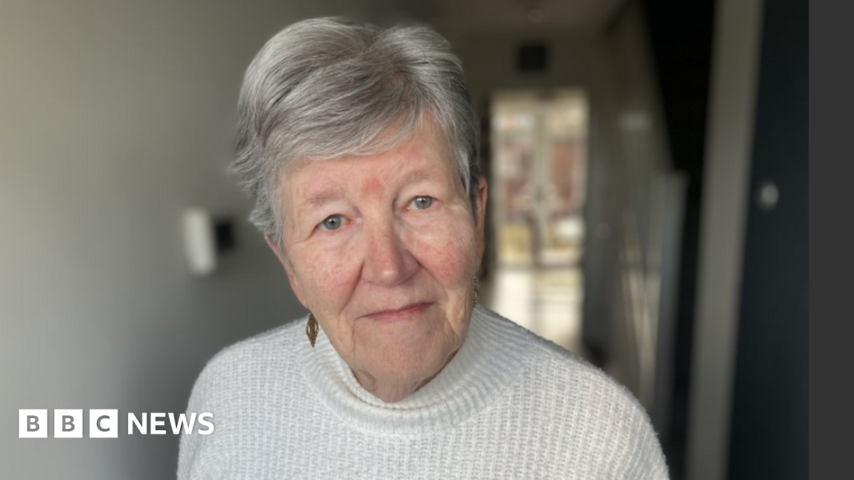 Sheila Jeffrey looking into the camera. She has short grey hair and is wearing a white jumper.