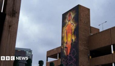 Part of a car park site has been painted to show an illuminated Brit Award in orange.