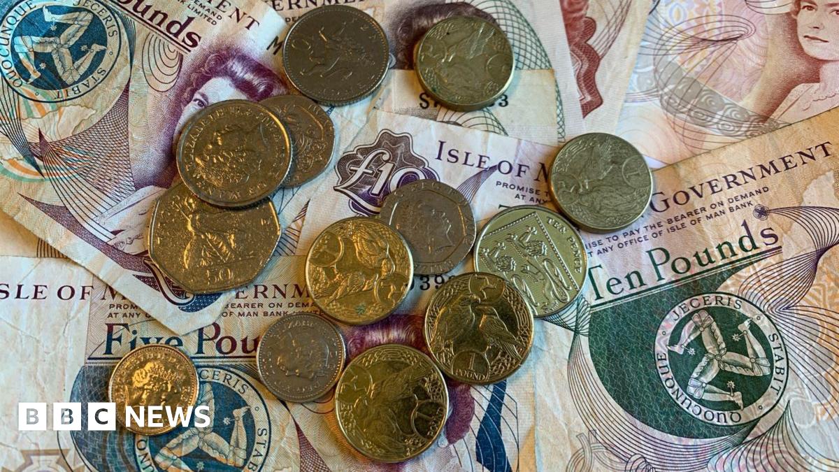 An assortment of Manx 10 and five pound notes, with a collection of coins on top of them - a mixture of pound coins, and small change.