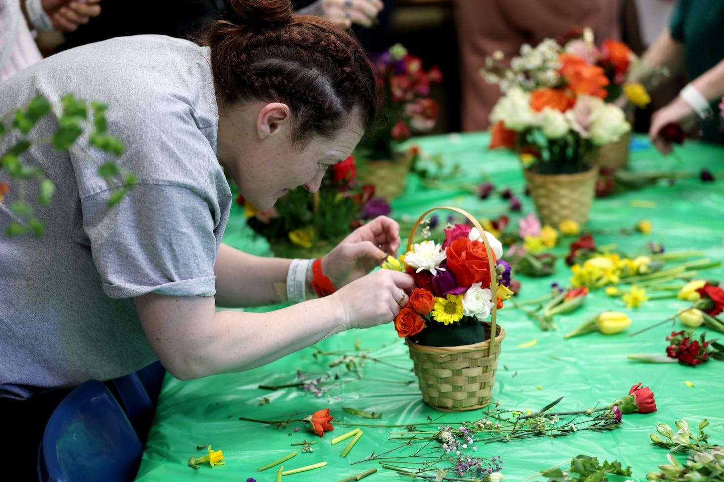 Jenni builds her bouquet during the Acton Garden Club Flower Day at Emerson Hospital.